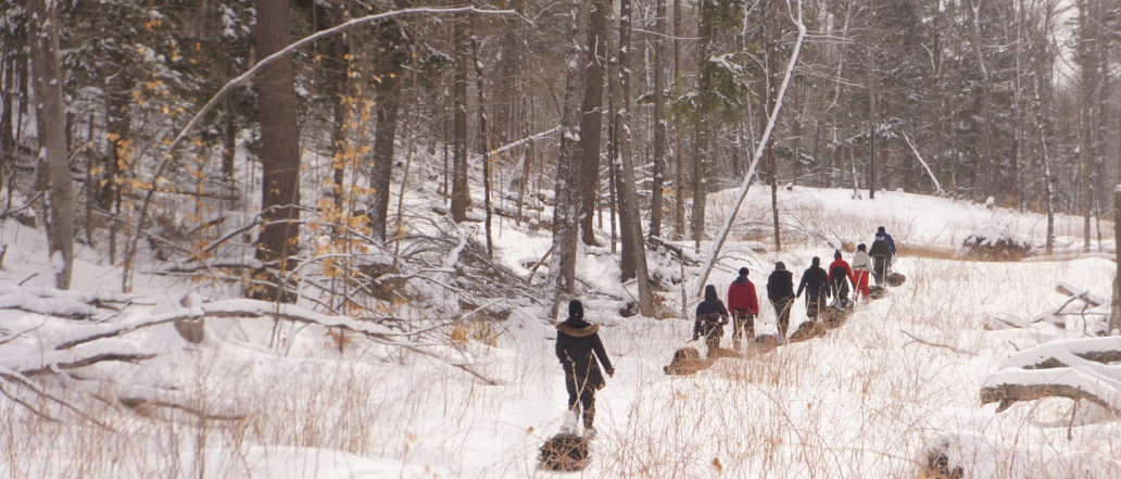 hikers trek through snowy forest