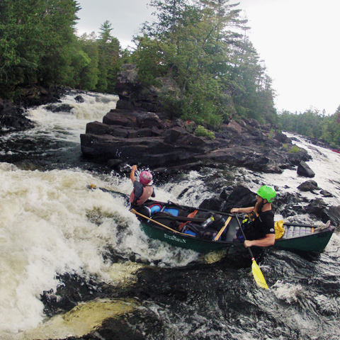 teens canoeing white water in ontario