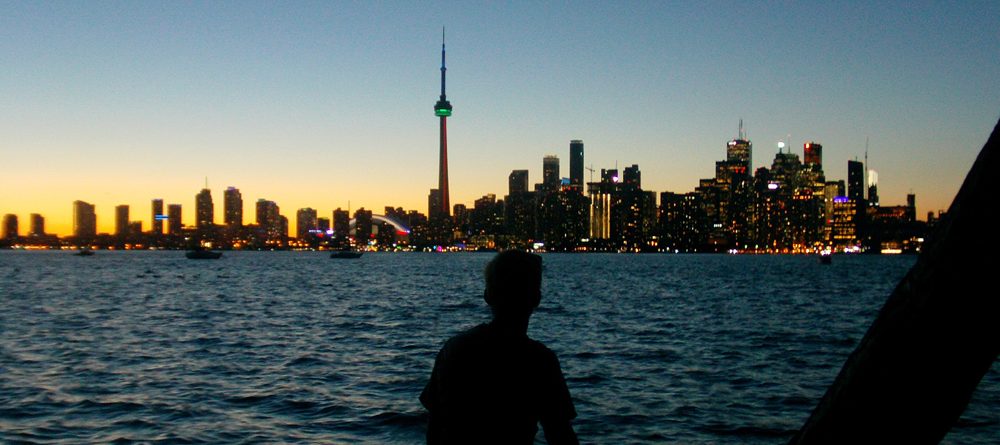 Participant looking back on Toronto from the island at sunset HEADER jpg 1000x445
