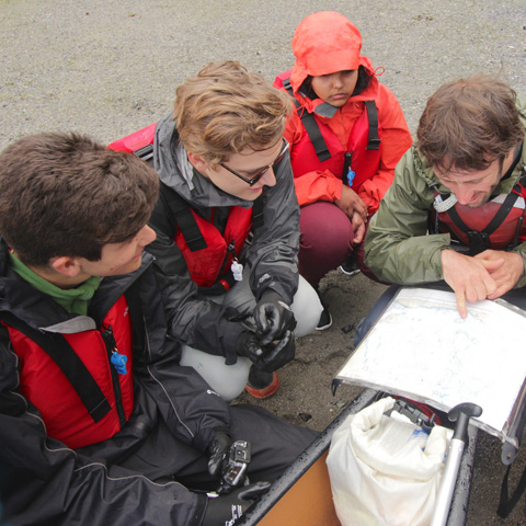 Students_gather_around_leader_to_navigate_map_together