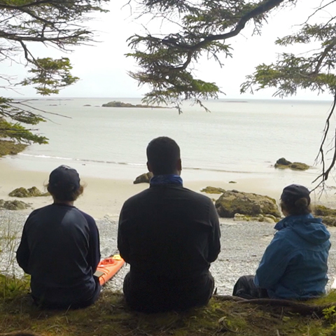 three indigenous youth looking out at Bay of Fundy