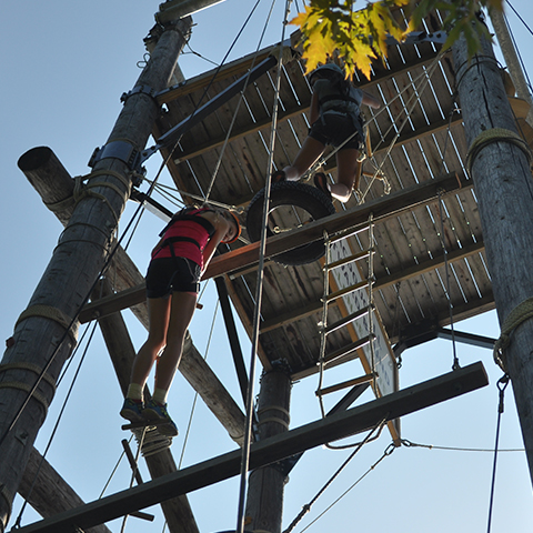 two-youth-climbing-high-ropes-structure
