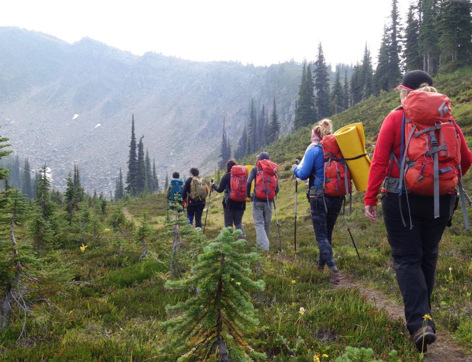 hikers walk into valley
