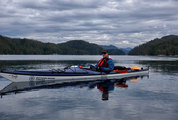 Image of a teen kayaking in the sea