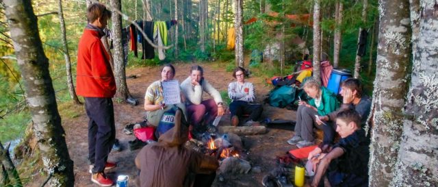 Image of a group of youth around a campfire