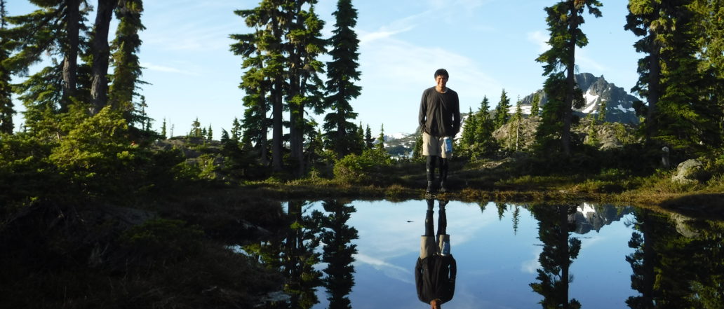 Person looking at reflection in water