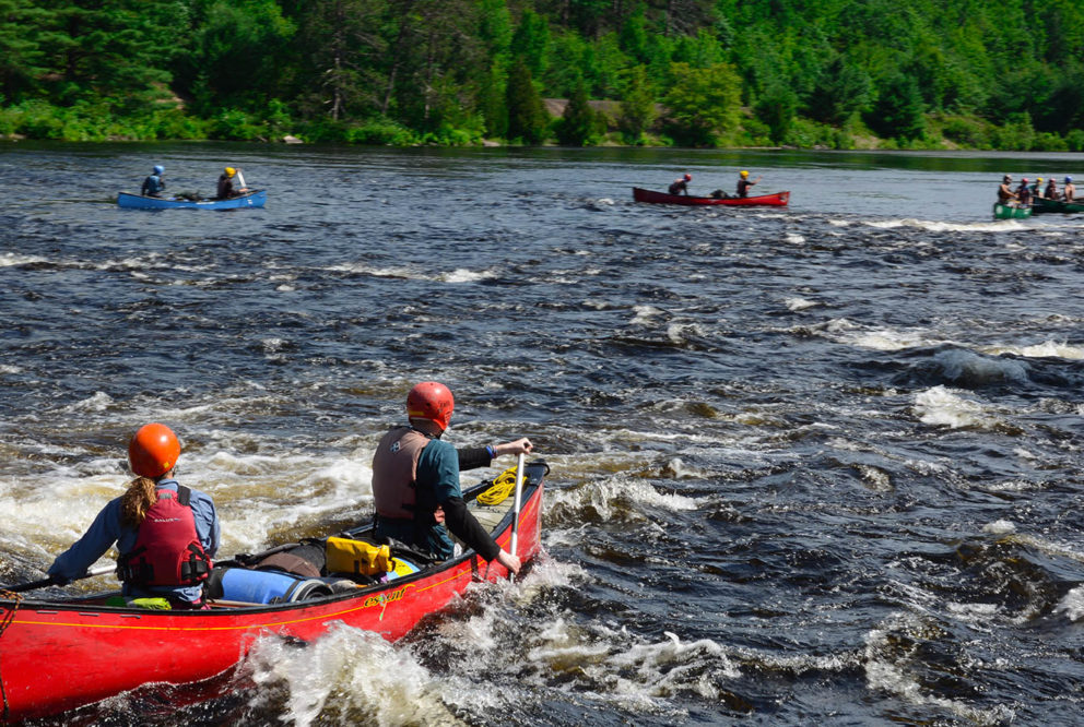 Image of a group of people canoeing in whitewater
