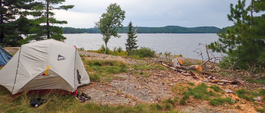 Image of a tent over looking a lake