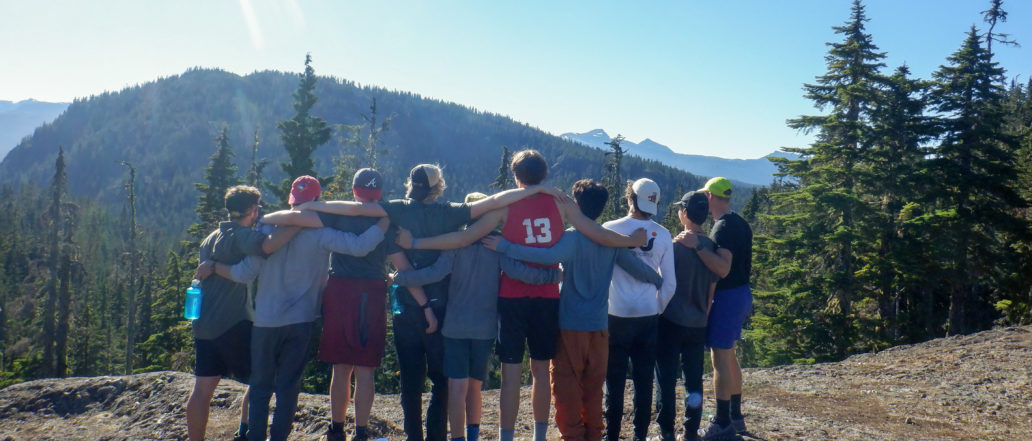 Image of 10 teens with their arms around each other