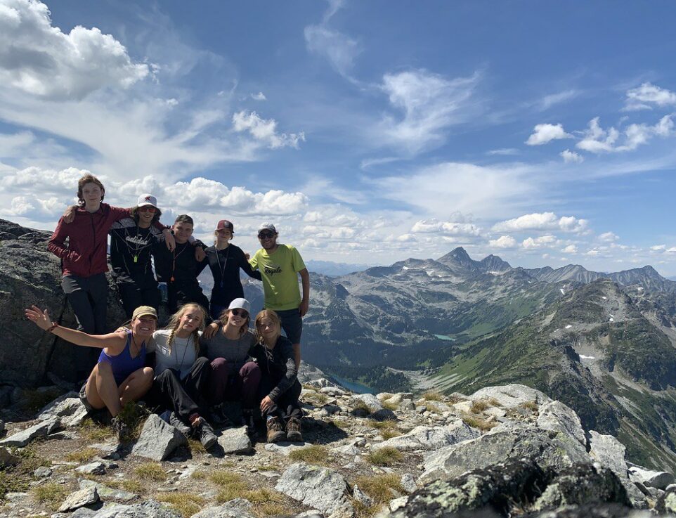 teens smiling atom a mountain