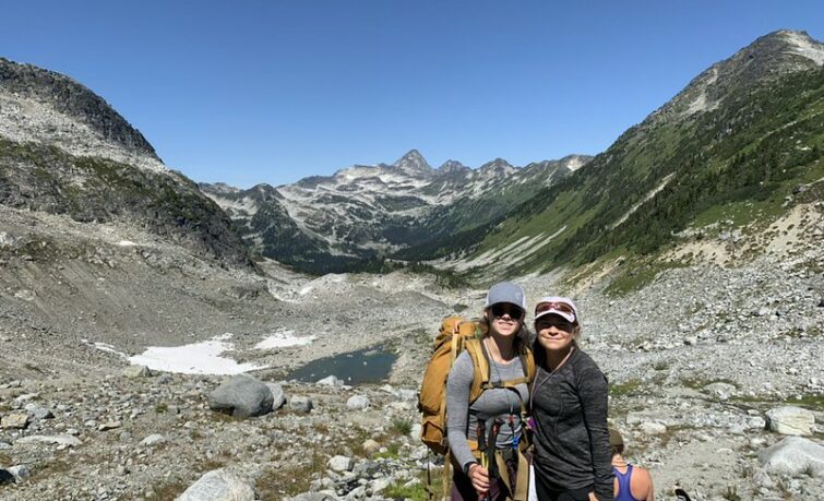 two girls posing infront of rocky mountains