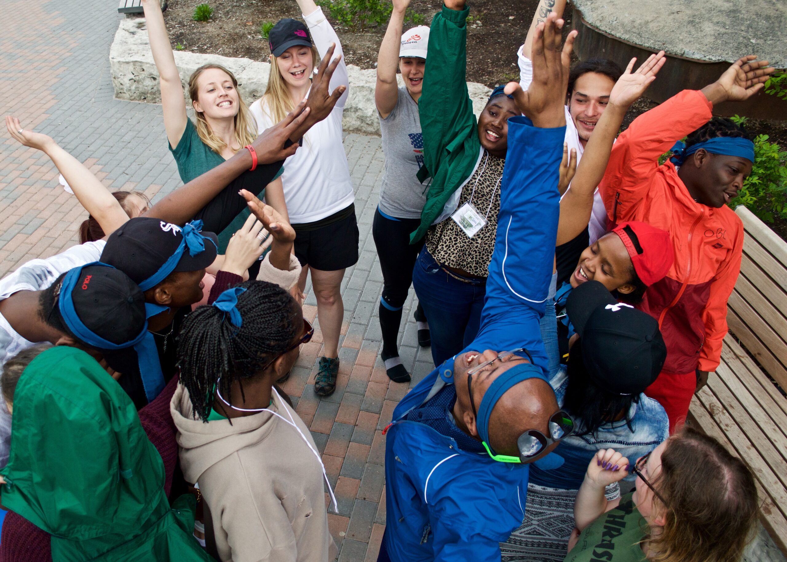 A group of teens with their hands raised after doing a cheer