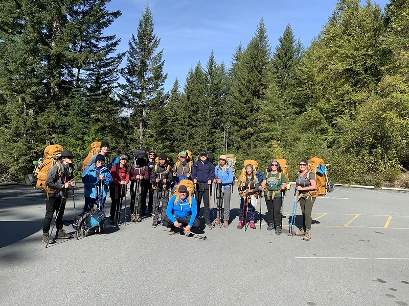 teens posing in front of a forest