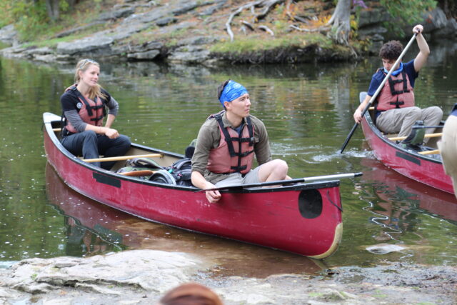 teens in a canoe on a lake