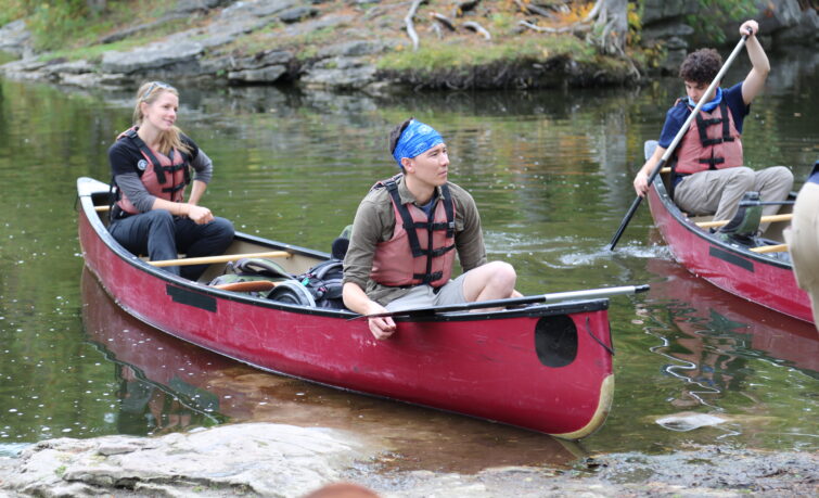 teens in a canoe on a lake