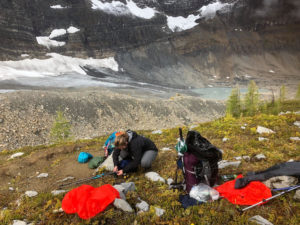girl setting up a tent