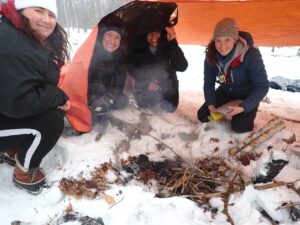 A group of people standing in the snow at our Make Peace with Winter conference