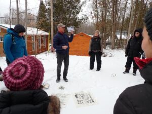 A group of people standing in the snow at our Make Peace with Winter conference