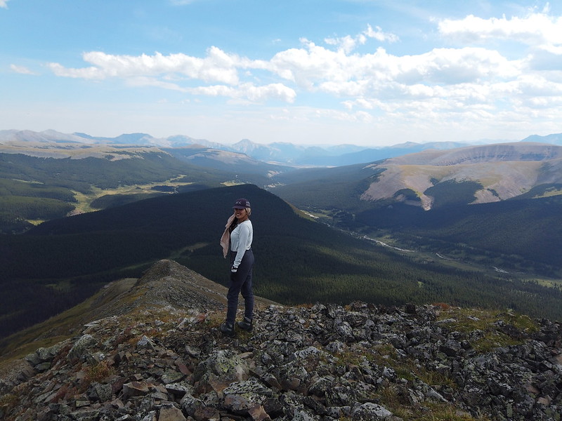 girl on mountain peak looking at camera
