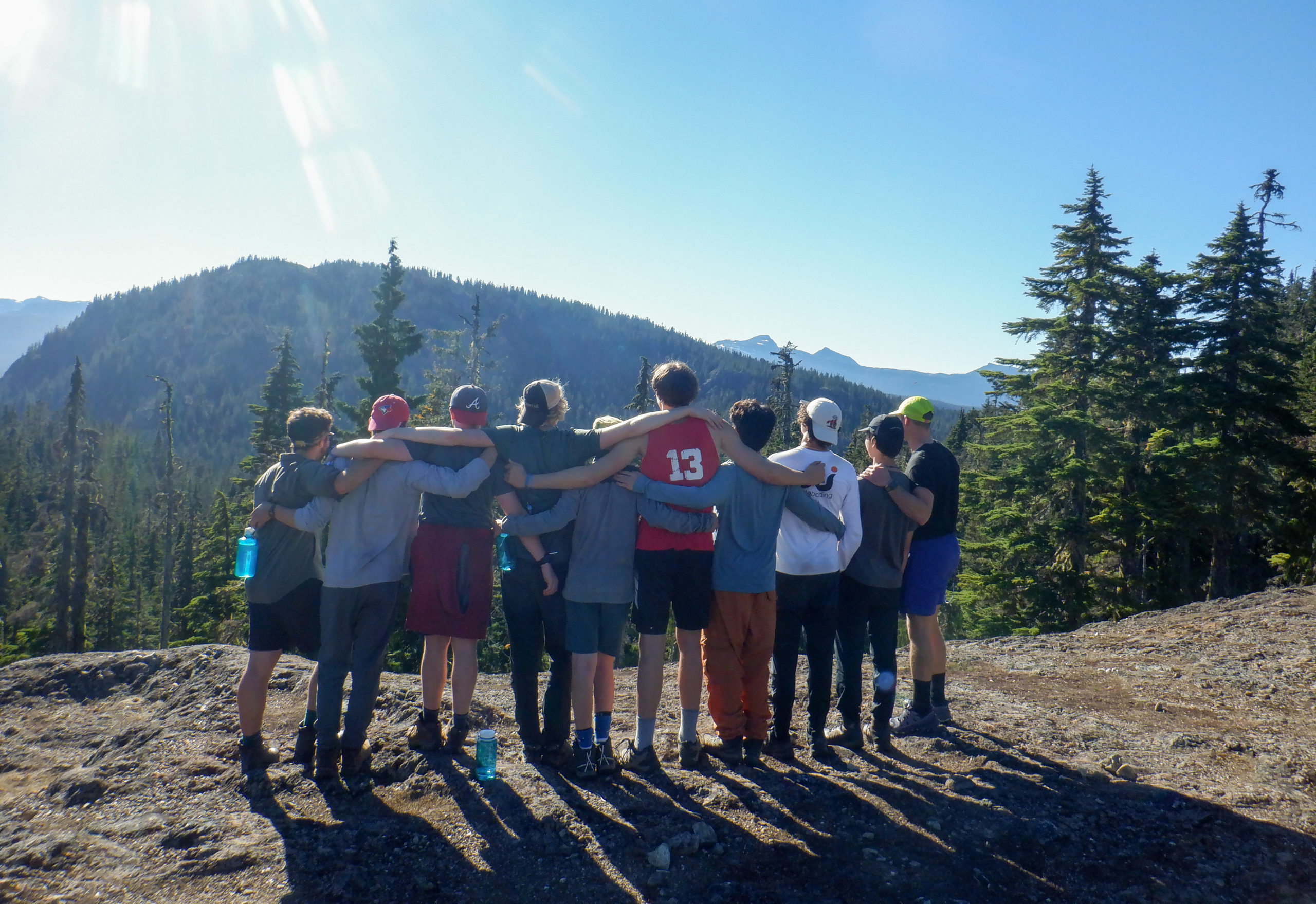 Image of 10 teens with their arms around each other