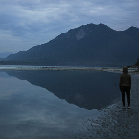 Maddy walking on the beach as dusk