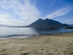 Image of a beach with the outline of a mountain in the distance.