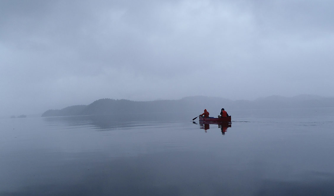 canoers on foggy lake