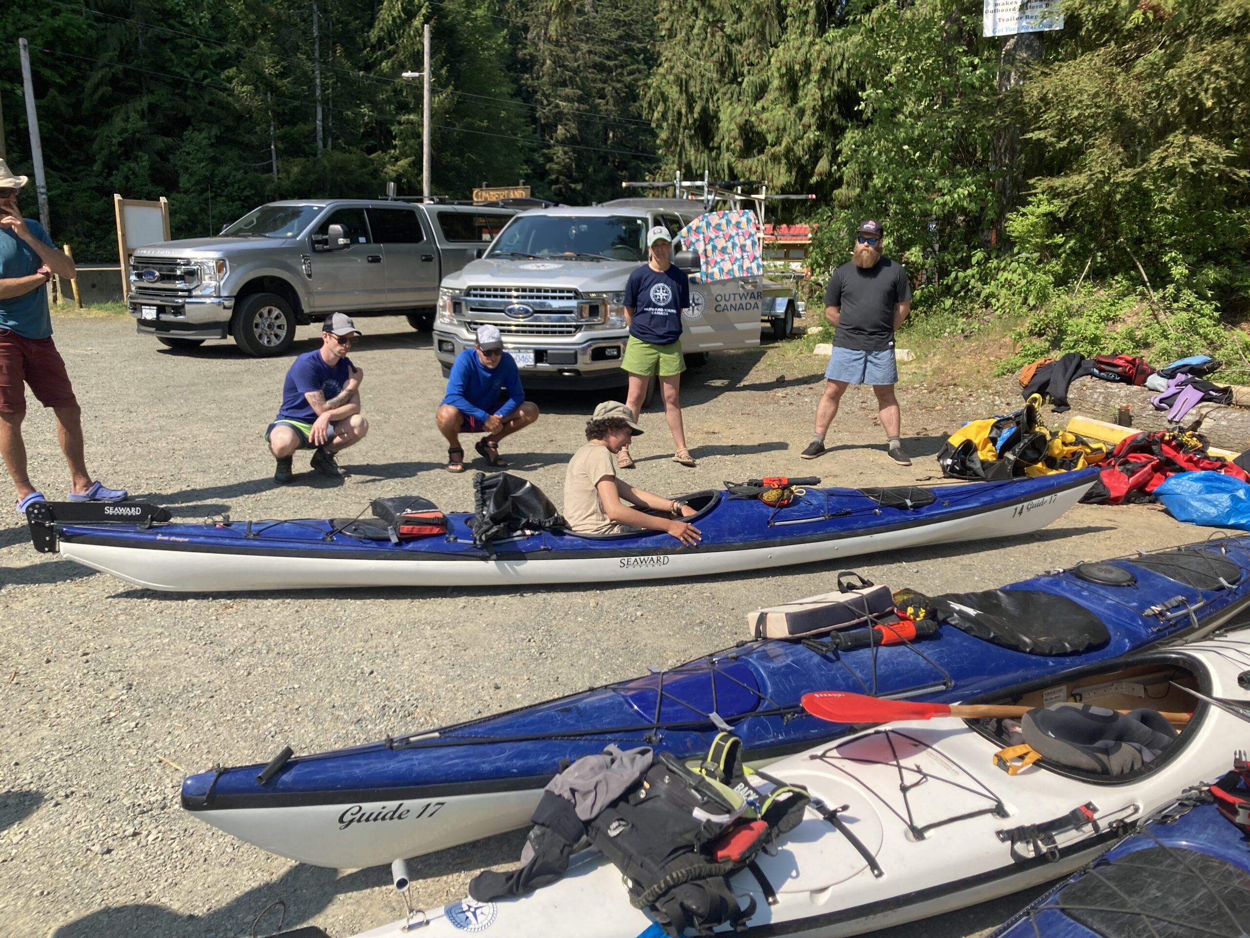 two kayaks on land with instructor inside