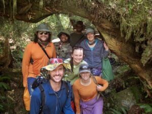 A group of 6 pose under log
