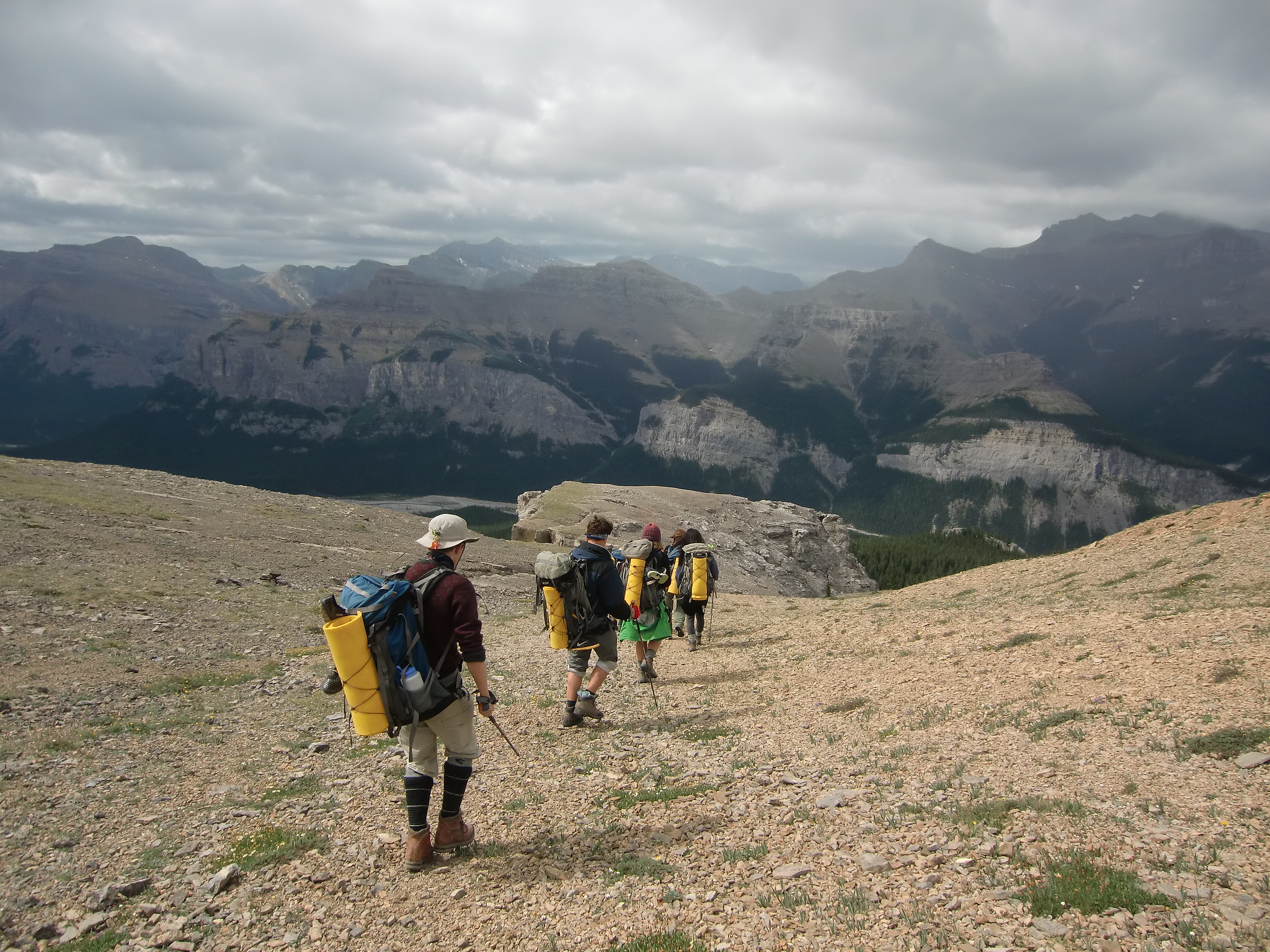 Young people hike on a mountain in the backcountry